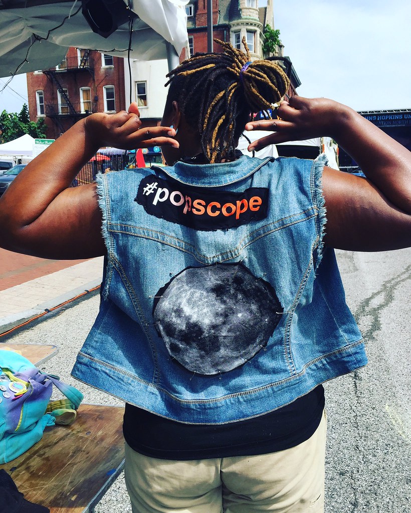 Volunteer with popscope logo and moon on her jacket.